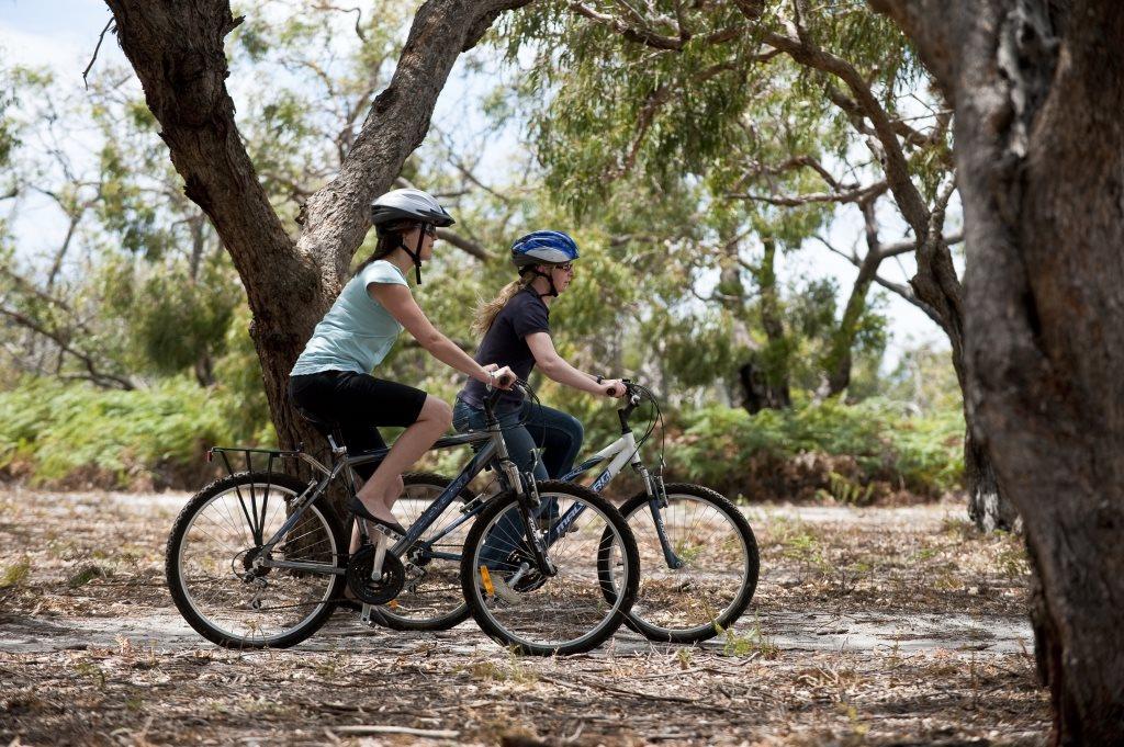 Two women cycling in the national park surrounding Paynesville